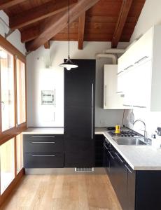 Casa la LunaにあるCasa FIENILEのキッチン(白黒のキャビネット、シンク付)