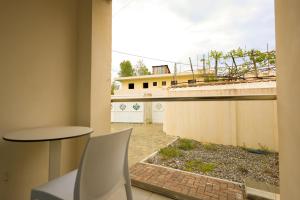 a room with a table and a chair and a building at Beach Guesthouse in Durrës