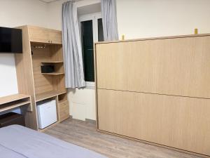 a room with a large sliding door in a bedroom at Hotel Esperia in Sanremo