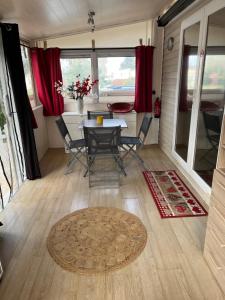 a dining room with a table and chairs in a tiny house at MOBIL HOME 200m de la mer in Hyères +15 photos