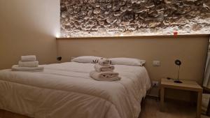 a bedroom with a bed with towels on it at Sikelia House Cefalù in Cefalù