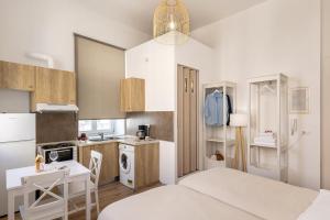 a small kitchen with a bed and a table at Irene Studios in Ermoupoli