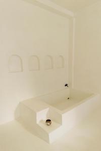 a white room with a sink in the middle of it at The Hidden Home in Patong Beach