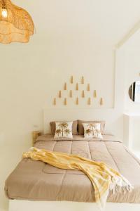 a bedroom with a large bed with a blanket on it at The Hidden Home in Patong Beach +2 photos