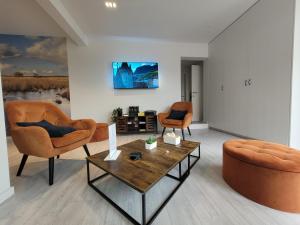 a living room with two chairs and a coffee table at d'Ereplatse in Zuienkerke