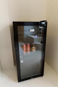 a small refrigerator with some red cans in it at The Hidden Home in Patong Beach
