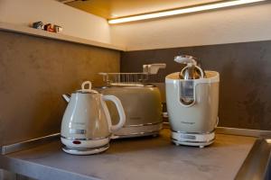 three appliances sitting on a counter in a kitchen at Tormini Scalo in Roe