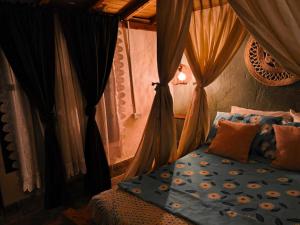 a bedroom with a bed with a canopy at Bohemio Chic House - Alojamiento con vista al bosque a 45 minutos de Medellin en Santa Elena in Santa Elena +71 photos