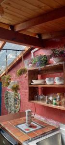 a kitchen with a counter with pots and pans at Bohemio Chic House - Alojamiento con vista al bosque a 45 minutos de Medellin en Santa Elena in Santa Elena