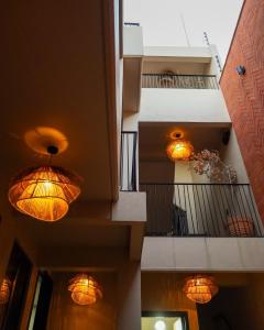 two lights hanging from the ceilings of a building at Bacaanda #1 in Oaxaca City