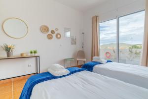 En eller flere senge i et værelse på Casa Mieiro - Porto Santo