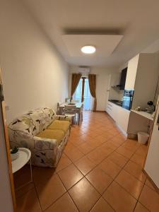 a living room with a couch and a kitchen at GENLIS Home in Cardito
