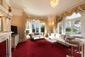 a living room with a couch and a fireplace at The Annan Hotel in Llandudno