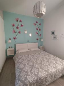 a bedroom with a bed and flowers on the wall at Isaias house in Rhodes Town