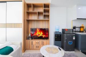 a living room with a fire in a entertainment center at Gold park homes in Nairobi