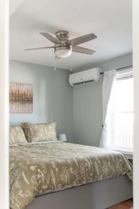 a bedroom with a bed with a ceiling fan at Fabulous 3bdrm Home With Parking in Highland Falls