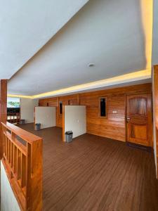 a large room with wooden walls and wooden floors at Zahra Homestay in Senaru +20 photos