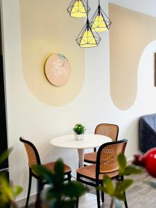 a dining room with a white table and chairs at Thỏ homestay in Gia Lâm Pho +5 photos