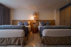 Postel nebo postele na pokoji v ubytování Hotel Calypso Cancun