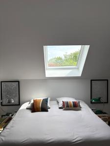 a bedroom with a bed with a window above it at Studio Fourchaume in Chablis