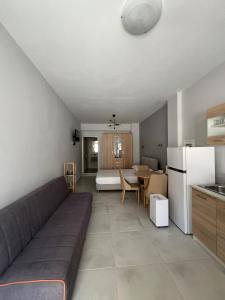 a living room with a couch and a kitchen at Tillo apartments in Syvota