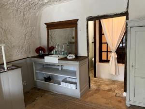 a bathroom with a sink and a mirror at Charming troglodyte near Amboise in Pocé-sur-Cisse