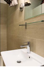 a bathroom with a white sink and a mirror at 34m2 cosy proche métro in Ivry-sur-Seine +15 photos
