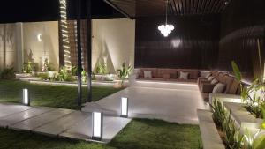 a living room with couches and tables and grass at Luxurious villa in Riyadh