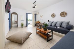 a living room with a blue couch and a table at Blue Heart Luxury Suites in Agia Anna Naxos