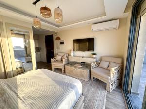 a bedroom with a bed and a living room at velora Studio roof in sodic villette compound in New cairo
