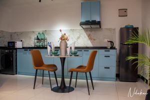 ダル・エス・サラームにあるNdekai Coveのキッチン(テーブル、椅子2脚、シンク付)