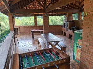 an outdoor entertaining area with a pool table and a table at Chácara Recanto das Águas in Juquitiba