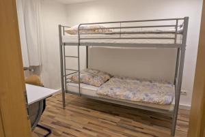 two bunk beds in a room with a wooden floor at FeWo Römerweg in Neustadt an der Weinstraße +15 photos