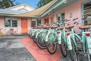 a row of bikes parked outside of a pink building at Step Back in Time- Golden Era Retro Motel in Saint Augustine