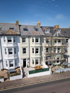an apartment building under construction on a city street at Stunning Townhouse by the sea, Hot Tub sleeps 17 in Seaton