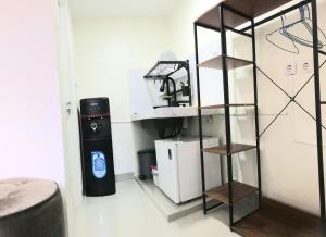 a room with a shelf and a trash can at Compound holiday home - 1 bedroom - Backyard Loft in Wonosobo