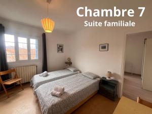 a bedroom with a bed and a chair and a window at U pozzu hôtel in Evisa
