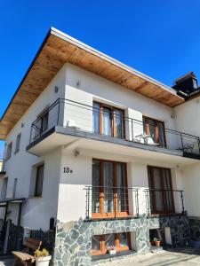 a white house with a balcony at Willa na Wilcznik in Zakopane