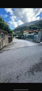an empty road in front of a building with a bridge at Appartamenti Estera 2 in Malcesine +8 photos