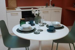 a white table with chairs and plates and wine glasses at Prestige and comfort in the center of Perugia and views in Perugia +59 photos