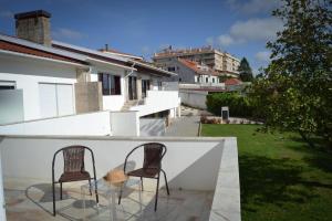 two chairs and a glass table on a balcony at SANTA RITA Guesthouse B&B in Vila Nova de Gaia