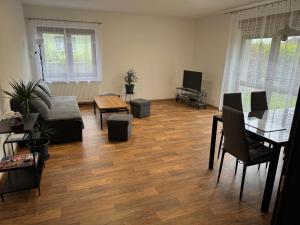 a living room with a couch and a table at Apartmán Luby in Cheb