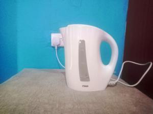 a white mixer in a room with a blue wall at Rose Gardens in Kitale