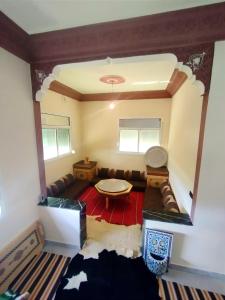 a living room with a couch and a table at Gite touristique bouknala in Abinane