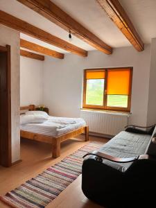 a bedroom with two beds and a window at Casa alpin in Izvoru Mureşului