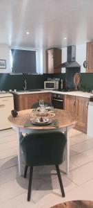 a kitchen with a table in the middle of it at Le Studio 1044 in Le Crotoy