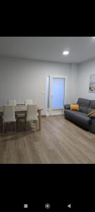 a living room with a couch and a table at Pensión Castineiras in Sarria +2 photos