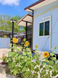 une maison avec des tournesols dans la cour avant dans l'établissement Mook Raya Resort, à Ko Muk 18 autres photos