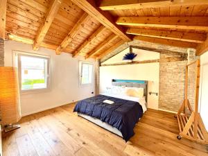 a bedroom with a bed in a room with wooden ceilings at Serenity in Mestre