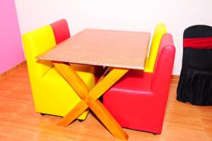 a table and chairs in a room at Palm Resort in Gūdalūr